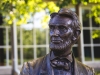 Statue of Abraham Lincoln Sitting With Green Blurry Leaf Bokeh And White Window Frame In Background, Gettysburg Battlefield, Pennsylvania, United State